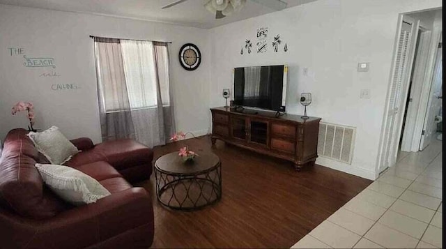 living room featuring dark hardwood / wood-style floors and ceiling fan