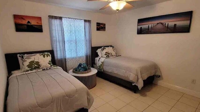 bedroom with ceiling fan and tile patterned flooring