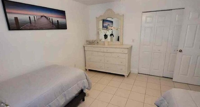 tiled bedroom with a closet