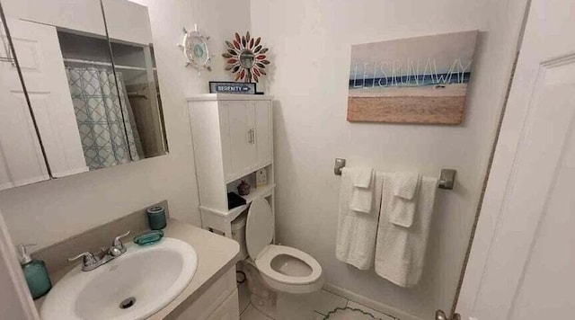 bathroom with tile patterned flooring, vanity, toilet, and curtained shower