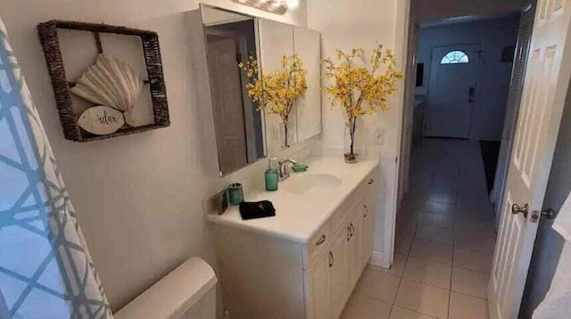 bathroom featuring tile patterned flooring, vanity, and toilet