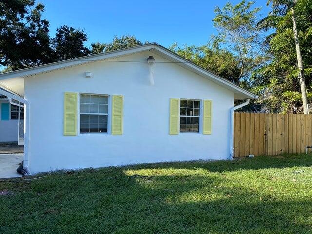 view of side of property with a yard