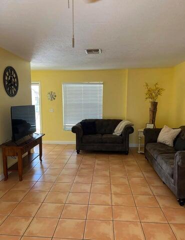 tiled living room with a textured ceiling