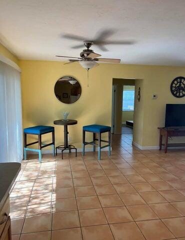 dining room with ceiling fan and light tile patterned floors