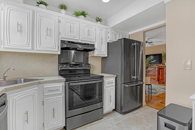 kitchen with sink, ceiling fan, light tile patterned floors, white cabinetry, and stainless steel appliances