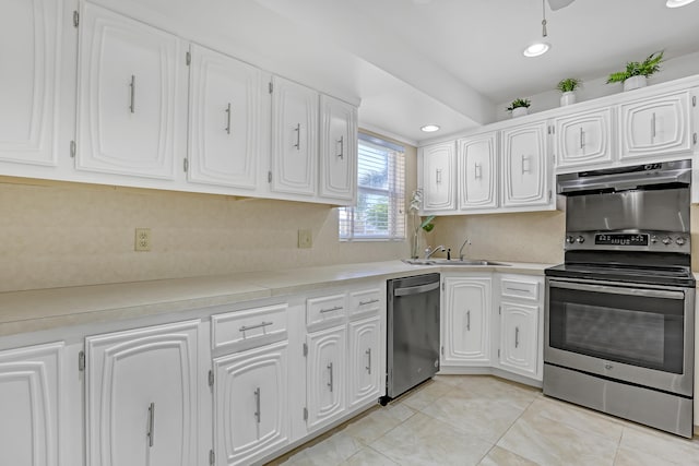 kitchen with white cabinetry, sink, light tile patterned flooring, and stainless steel appliances