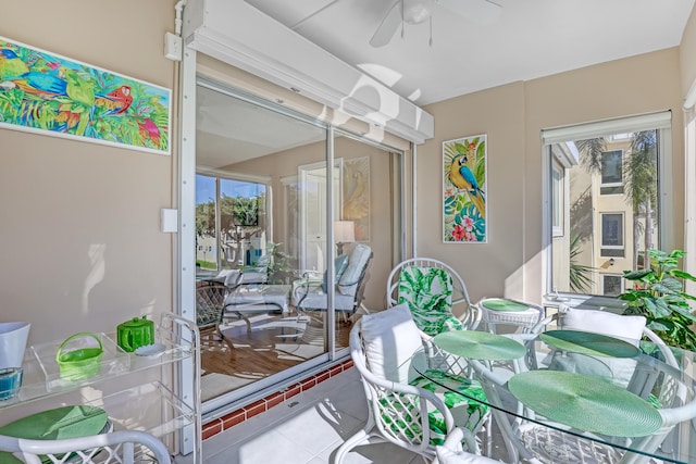 sunroom / solarium featuring plenty of natural light and ceiling fan