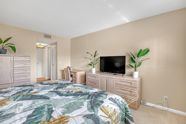 carpeted bedroom featuring a textured ceiling