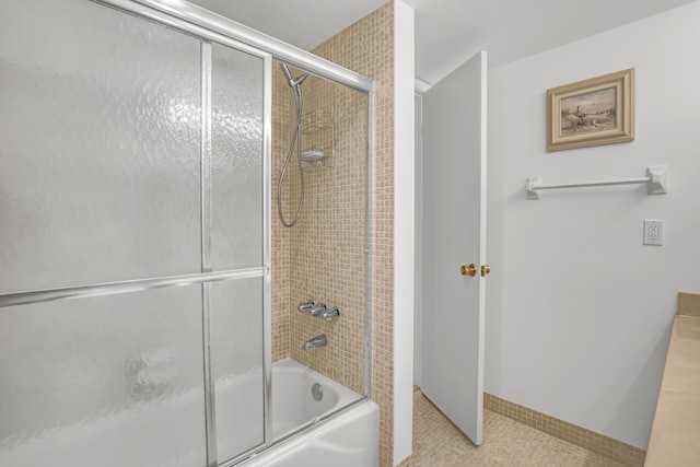 bathroom with shower / bath combination with glass door and tile patterned floors