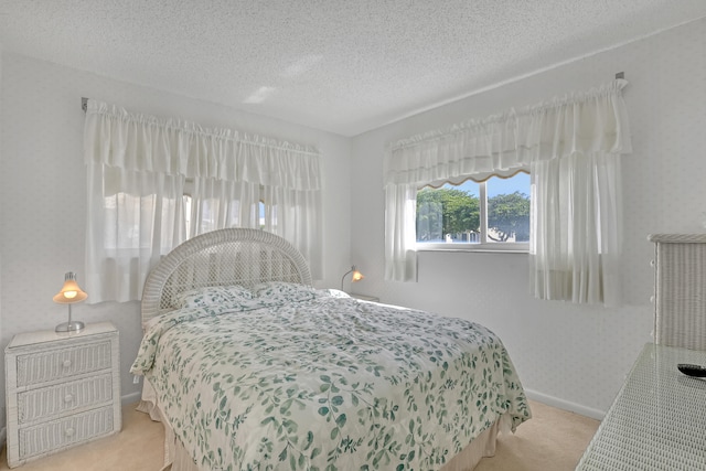 carpeted bedroom featuring a textured ceiling