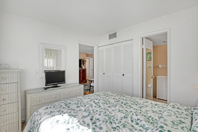 bedroom featuring hardwood / wood-style floors and a closet