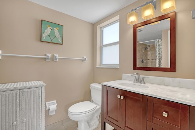 bathroom with tile patterned floors, vanity, toilet, and curtained shower