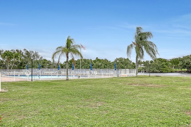 view of community with a yard and a swimming pool