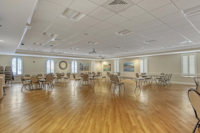 misc room with a paneled ceiling, light hardwood / wood-style flooring, and ornamental molding