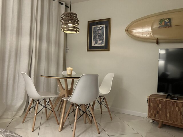 dining space featuring light tile patterned flooring