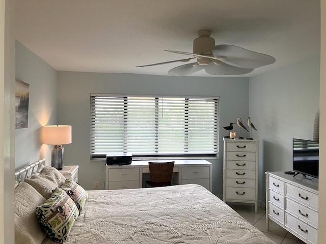 tiled bedroom featuring ceiling fan