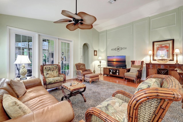 living room featuring hardwood / wood-style floors, french doors, ceiling fan, and lofted ceiling