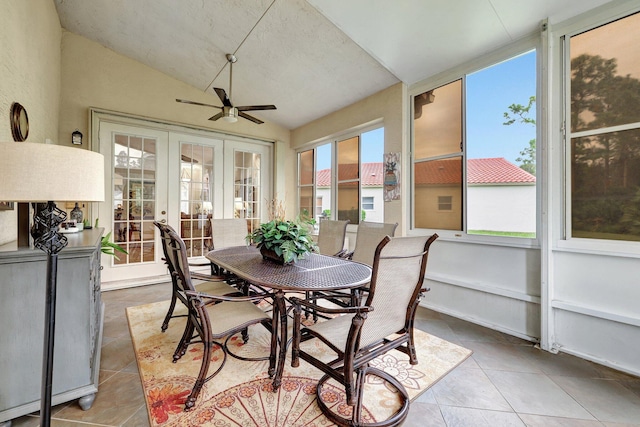 sunroom with ceiling fan, lofted ceiling, and french doors