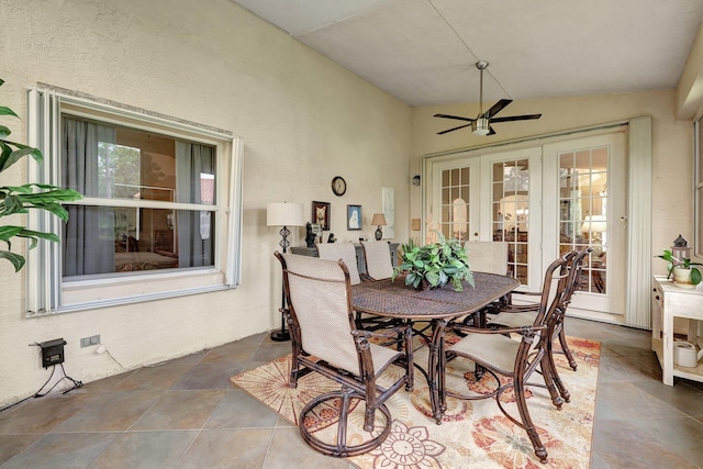 interior space with ceiling fan, french doors, vaulted ceiling, and tile patterned flooring