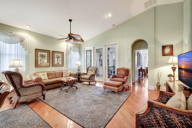 living room featuring ceiling fan, high vaulted ceiling, and hardwood / wood-style flooring