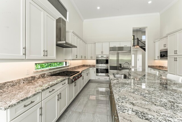 kitchen with white cabinetry, sink, ornamental molding, and appliances with stainless steel finishes