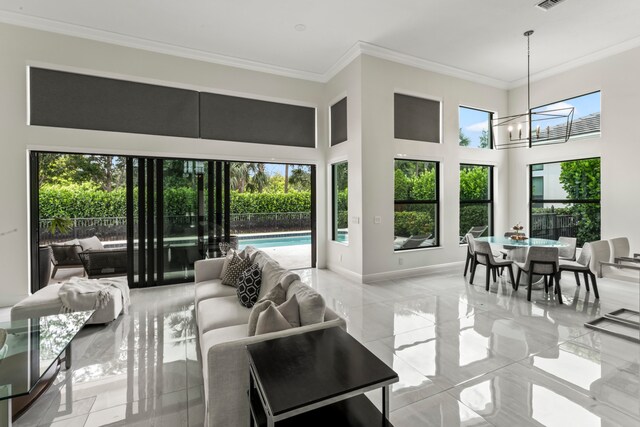 interior space with a high ceiling, ornamental molding, and a notable chandelier