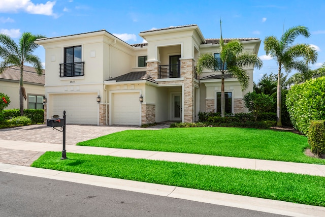 view of front facade featuring a balcony, a garage, and a front lawn