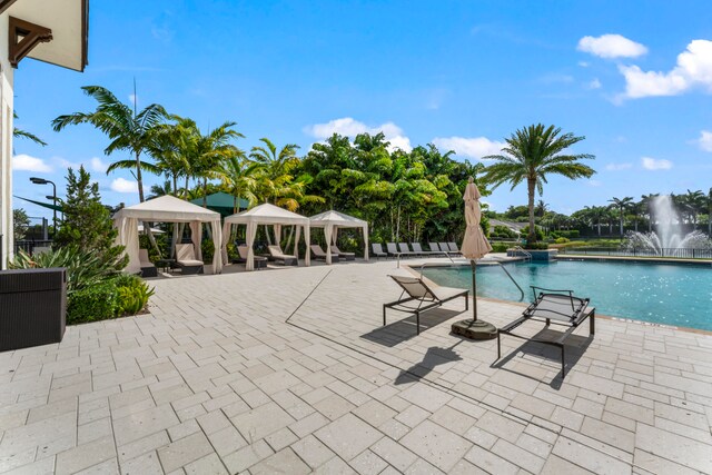 view of pool with a gazebo and pool water feature