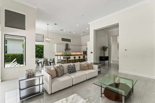 living room with a notable chandelier and ornamental molding