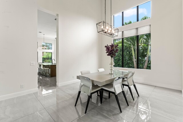 dining space with a wealth of natural light and a high ceiling