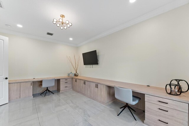 office area featuring built in desk and ornamental molding