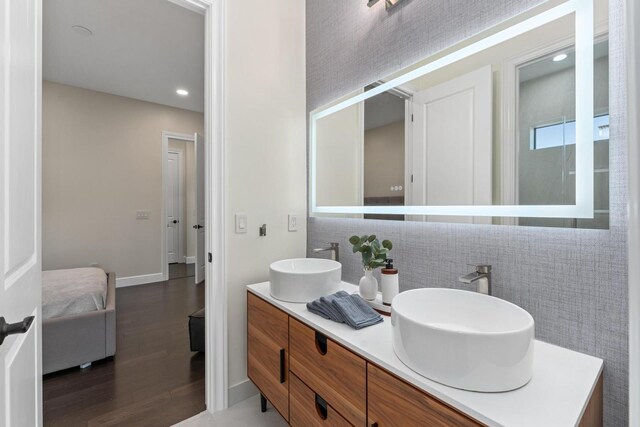 bathroom featuring vanity, hardwood / wood-style flooring, and tile walls