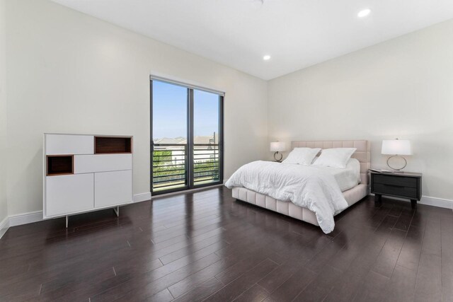 bedroom featuring dark hardwood / wood-style flooring and access to outside