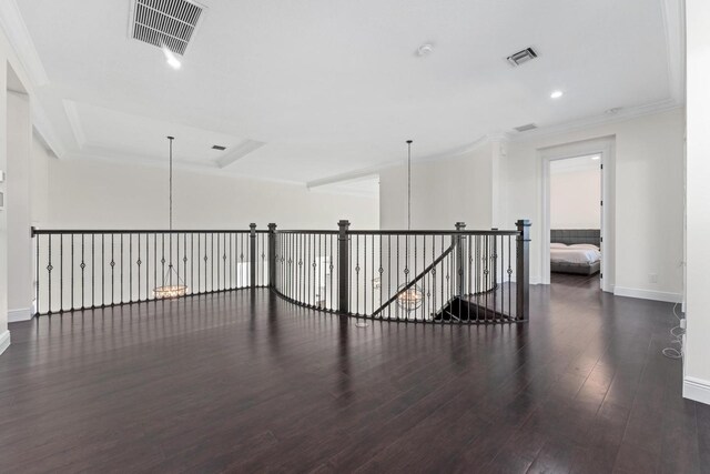 hall with dark hardwood / wood-style flooring, a chandelier, and ornamental molding