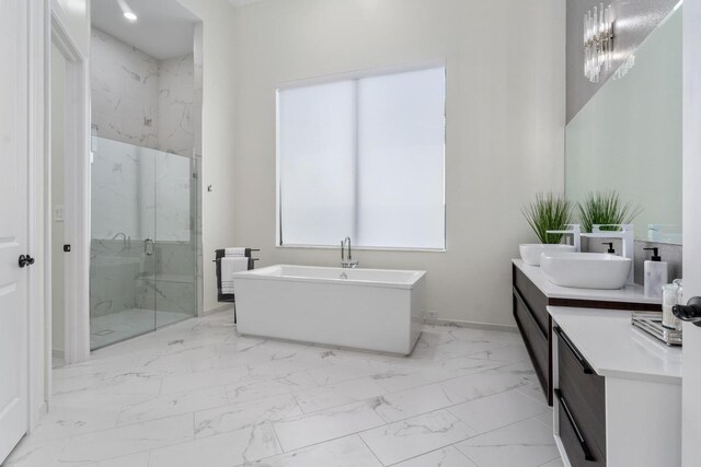 bathroom featuring vanity and independent shower and bath