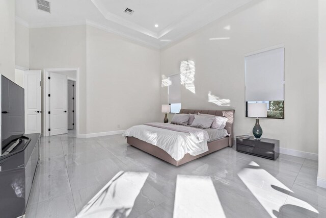 bedroom featuring a towering ceiling and ornamental molding