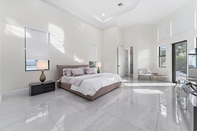 bedroom with a towering ceiling and ornamental molding