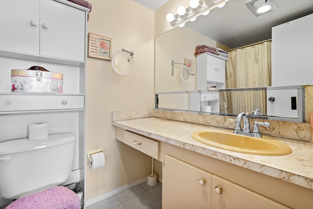 bathroom with toilet, vanity, tile patterned floors, and walk in shower