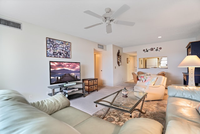 carpeted living room with ceiling fan