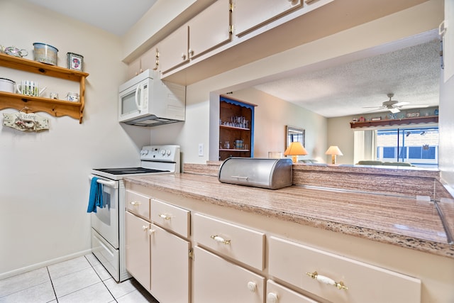 kitchen with ceiling fan, white cabinetry, a textured ceiling, white appliances, and light tile patterned floors