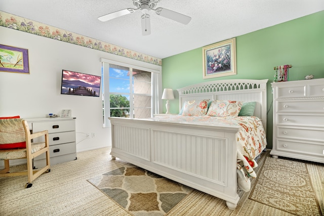 bedroom with a textured ceiling and ceiling fan