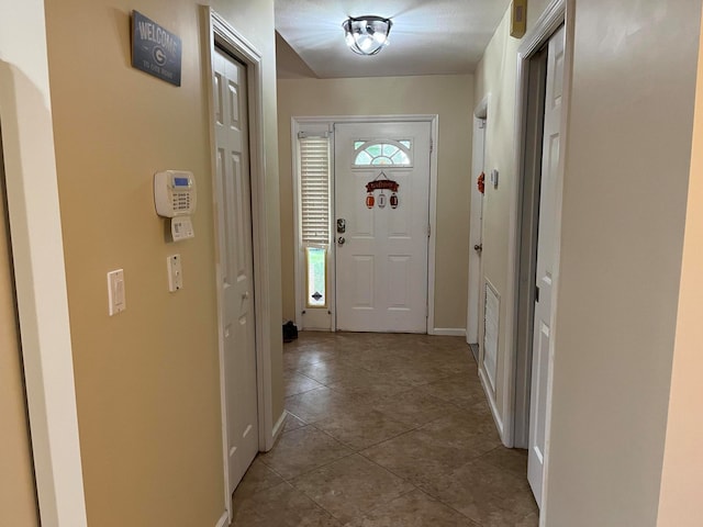 doorway to outside featuring light tile patterned floors