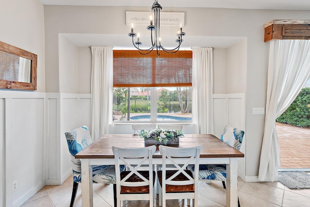 dining area featuring an inviting chandelier and light tile patterned flooring