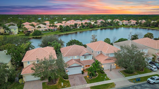 aerial view at dusk with a water view