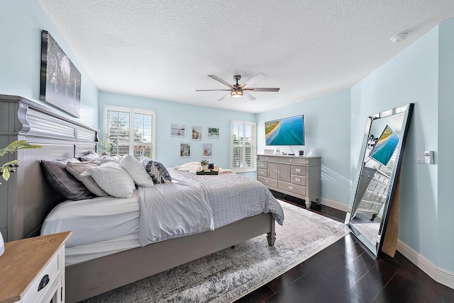 bedroom featuring a textured ceiling, dark wood-type flooring, and ceiling fan