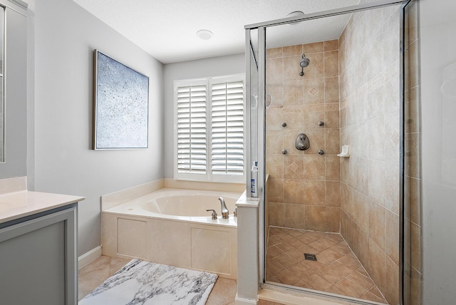 bathroom with vanity, independent shower and bath, and a textured ceiling