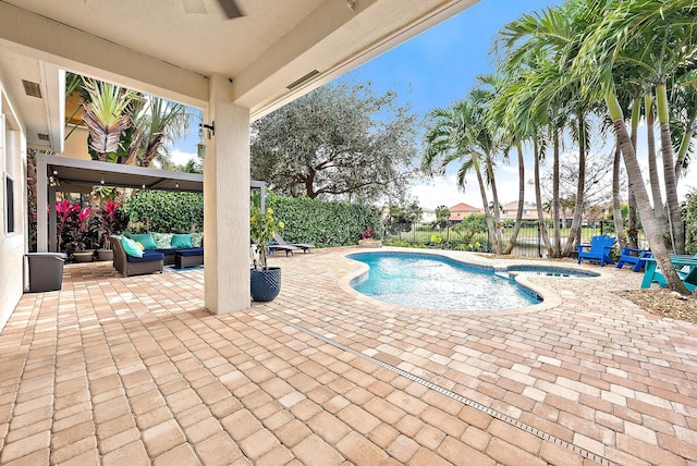 view of swimming pool with a patio area, outdoor lounge area, and an in ground hot tub