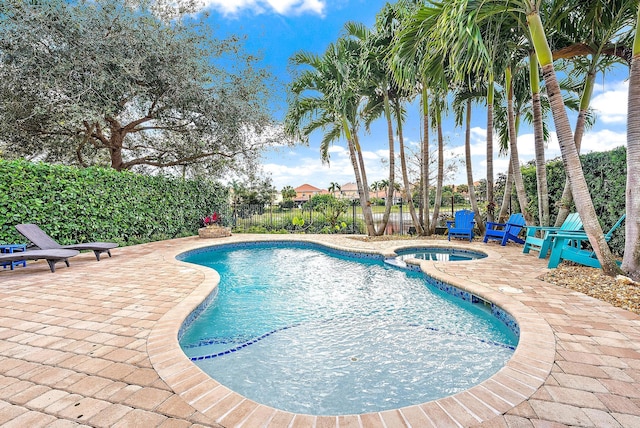 view of swimming pool featuring a patio area and an in ground hot tub