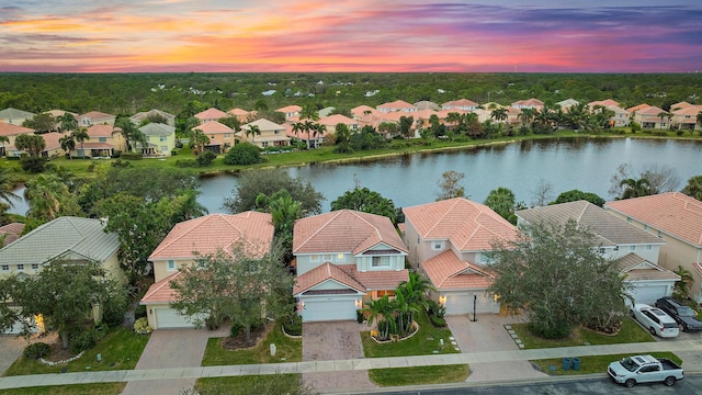 aerial view at dusk with a water view