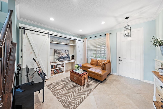 living room with crown molding, a barn door, light tile patterned flooring, and a textured ceiling